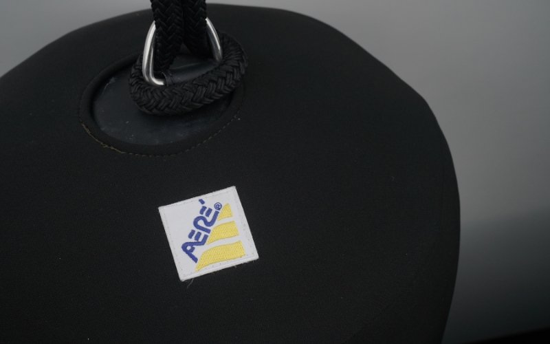 A close-up of a black fender from the company AERE, showing its design and material in detail