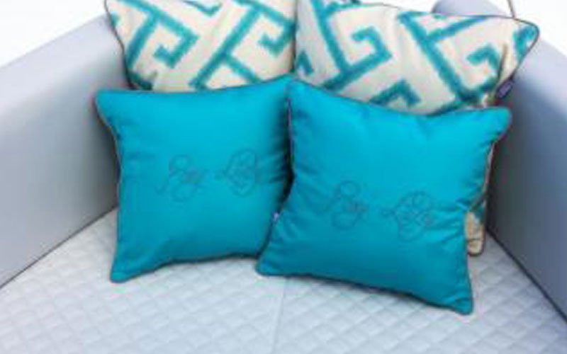 Yacht upholstery by Argola Textile Yacht Design on the exterior of a yacht anchored in a marina, creating a stylish and comfortable outdoor space