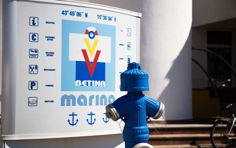 A sign with information about the marina, displaying details and facilities available for visitors