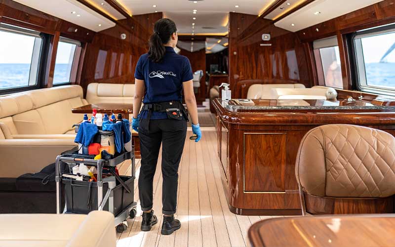 Crystal Clean team preparing cleaning equipment inside luxury yacht salon.