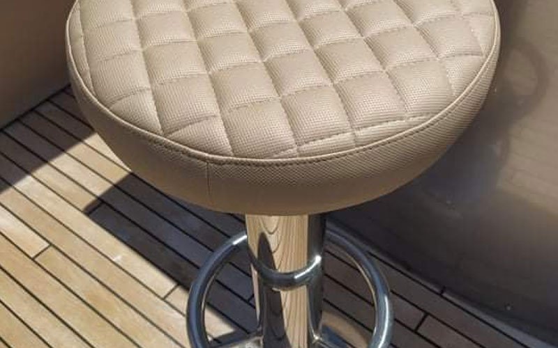 Close-up of premium leather upholstery on a yacht’s exterior seating, handcrafted by Dermavamvakakis