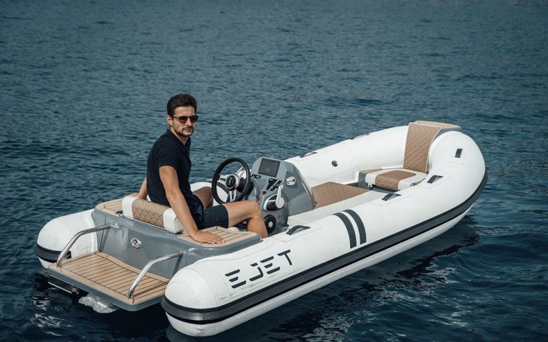 Man driving a jet-powered inflatable boat on the water