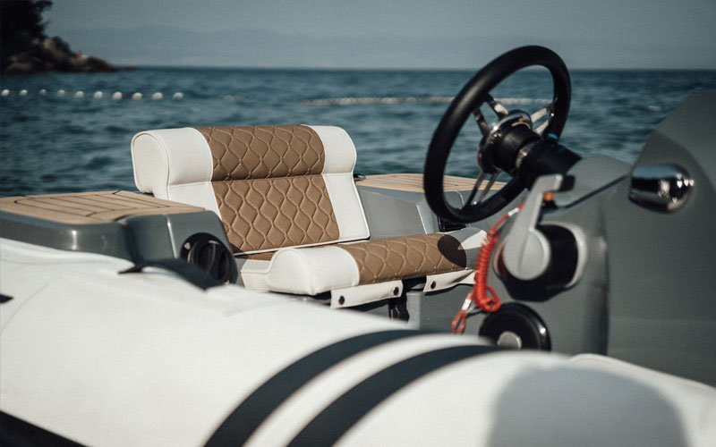 Man driving a jet-powered inflatable boat on the water