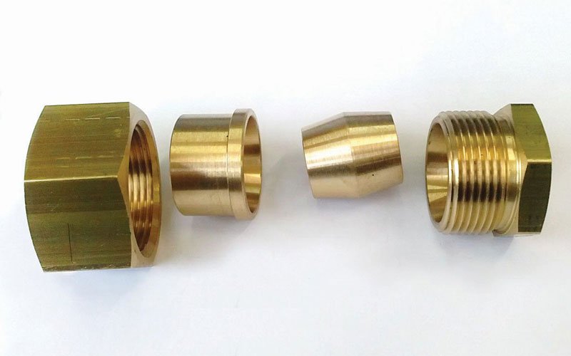 Disassembled brass fitting components showing precision machining by General Constructions Ifaistus