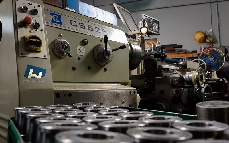 Industrial lathe machine producing high-precision metal parts at General Constructions Ifaistus