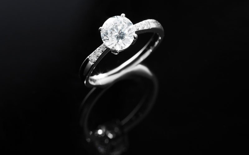 precious ring, single stone with diamond on black background