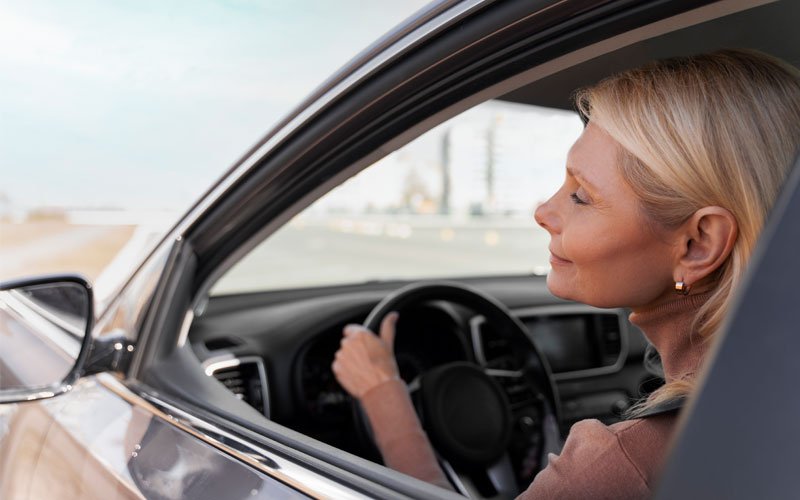optimistic woman driving her car confidently