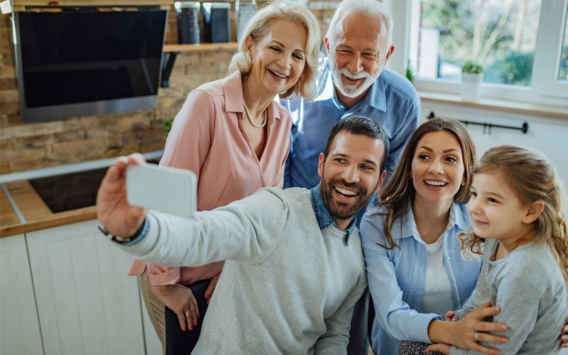 beautiful family taking selfie with grandparents