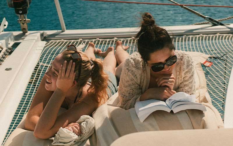 Luxury catamaran sailing experience with More Sailing in crystal clear Mediterranean waters, featuring relaxed guests on board, gourmet dining, and unforgettable sea views.