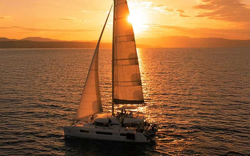 Luxury catamaran sailing experience with More Sailing in crystal clear Mediterranean waters, featuring relaxed guests on board, gourmet dining, and unforgettable sea views.