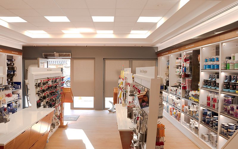 Interior view of Naval Store Yacht Supplies by Artemis Leros Boatyard, featuring light wood furniture and various products on display