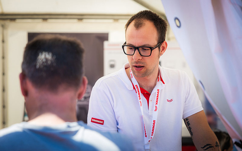 NAVELA representative presenting marine equipment solutions to a visitor at the exhibition stand.