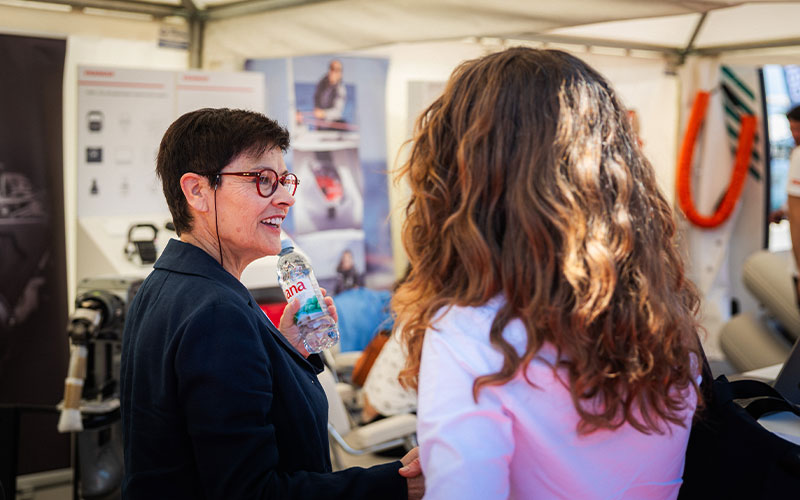NAVELA welcoming visitors and introducing marine products at the trade show booth.