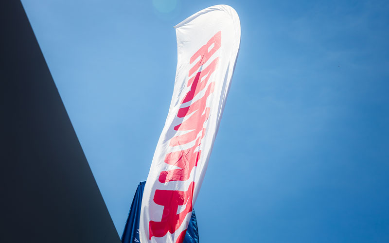NAVELA branded flag displayed outdoors during an international boating exhibition.