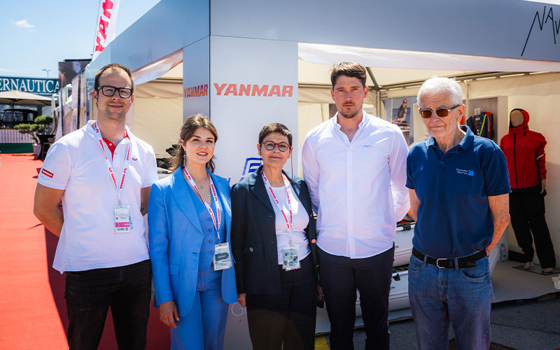 NAVELA team group photo with partners and representatives at the exhibition stand.