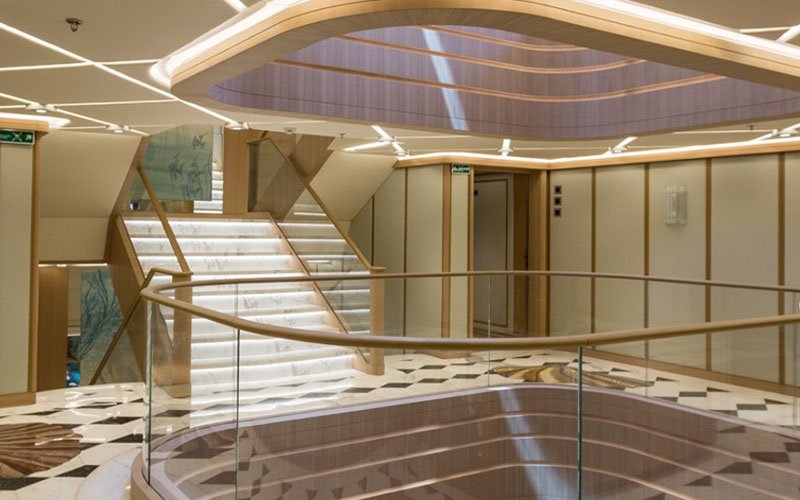 a modern, luxurious interior space with elegant stairways, soft lighting, and sleek materials. by the expert team of Sea Coat Innovations!