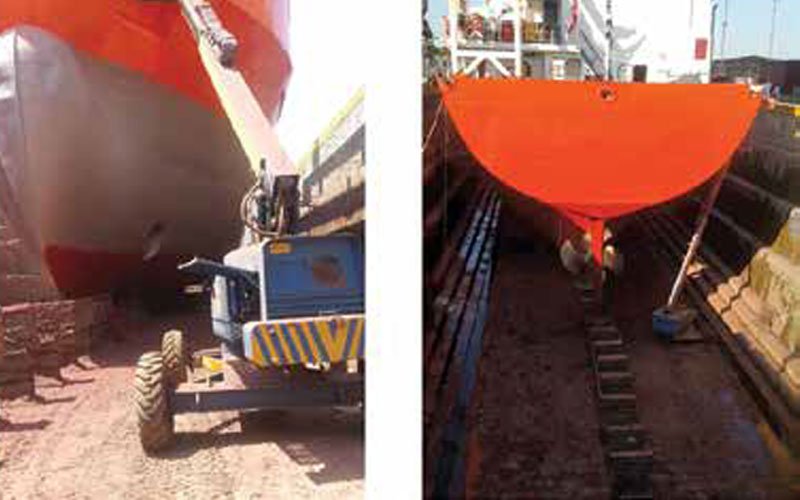 Two images showing a ship in dry dock. The left image displays a close-up side view of the ship's hull with a mobile crane operating underneath it. The right image shows a rear view of the ship's stern and rudder while it is positioned on supports in the dry dock.